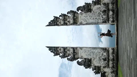Vertical shot of Bali sightseeing famous religious oriental gates, woman in Stock Footage 170474019
