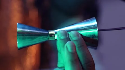 Vertical shot. Bartender make cocktail in a bar Pours alcoholic beverages at the Stock Footage 230558790