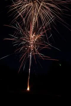 Vertical shot of a beautiful firework exploding on black background Foto stock