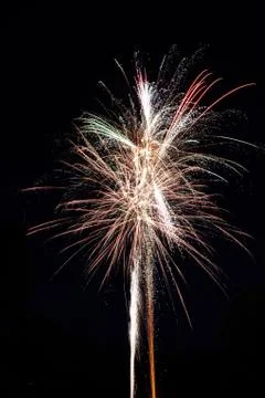 Vertical shot of a beautiful firework exploding on black background Stock Photos