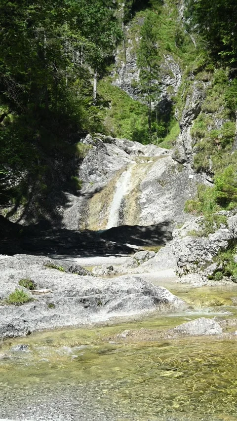 Vertical shot of a beautiful view on the main fountain at Staffelgraben mountain Stock-Footage 260940898