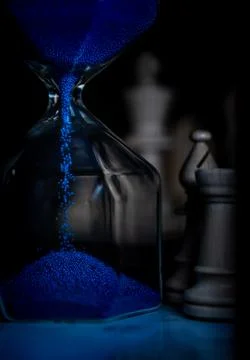 Vertical shot of a blue sand timer with blurred background Foto stock
