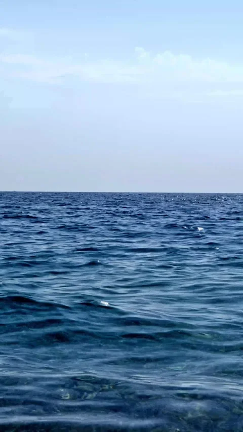 Vertical Shot of Blue Sea Waves Sparkling Under Sunlight Stock Footage 337670938
