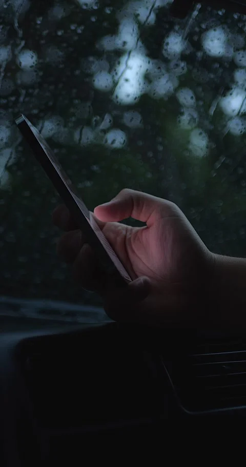 Vertical Shot Of Blurred Hand Holding Smartphone Behind... Stock Footage 332075601