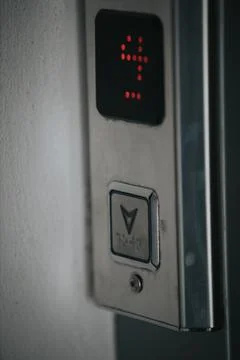 Vertical shot of a button of an elevator on the 4th floor Stockfoto's