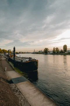 Vertical shot of a cargo beach in the river in Paris Stock Photos