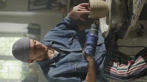 A vertical shot of a ceramist drying a clay product on a potter's wheel. Stock Footage 247246728