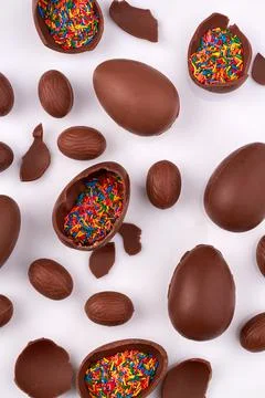 Vertical shot of choco eggs with rainbow sprinkles filling. Stock Photos