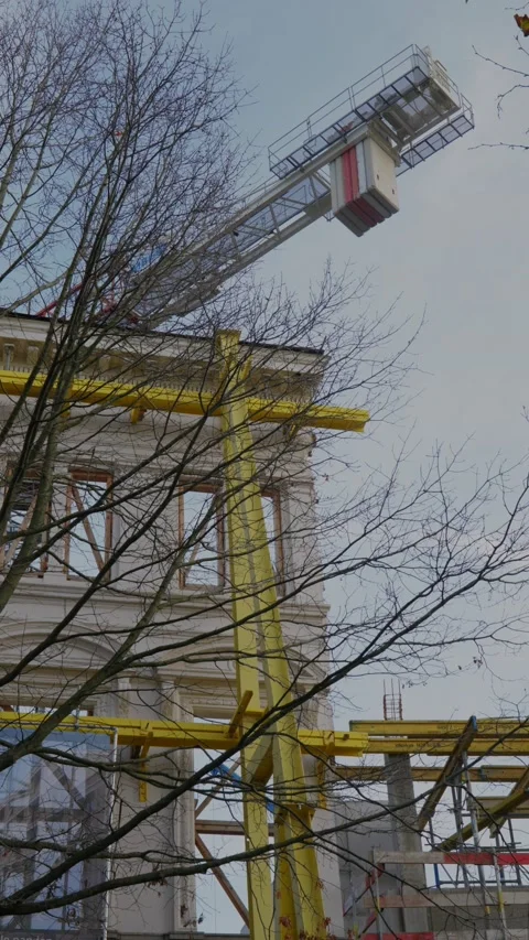 Vertical shot of classic housefront facade renovation with construction crane Видео 222074192