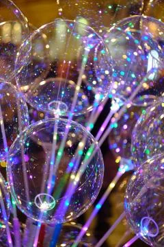 A vertical shot of a clear bubble balloon luminous LED lights string with blu Stock Photos