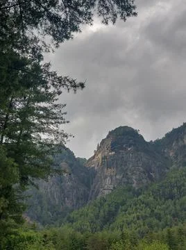 Vertical shot of the cliffs under a stormy sky in Paro, Bhutan Stock Photos