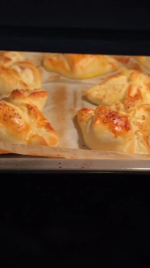 VERTICAL SHOT Close up of burger buns with sesame seeds baking in the hot oven.  Stock Footage 289438023