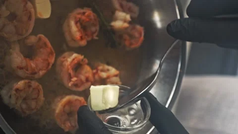 Vertical shot, Close-up of shrimps being fried in oil pan with butter Stock Footage 230561982