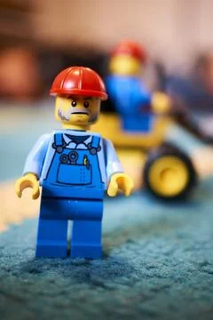 Vertical shot of a construction worker toy figure team with red helmets Stock Photos