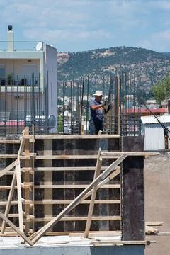Vertical shot of a constructor working on an unfinished building Stock Photos