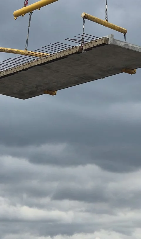Vertical shot of crane installing precast concrete floor Stock Footage 337847561