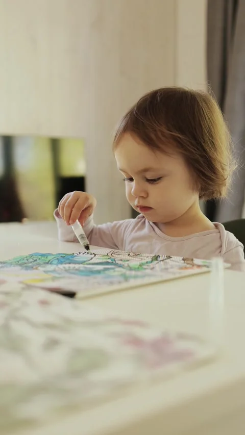 Vertical shot. A creative child enthusiastically drawing at home, completely Stock Footage 308971764