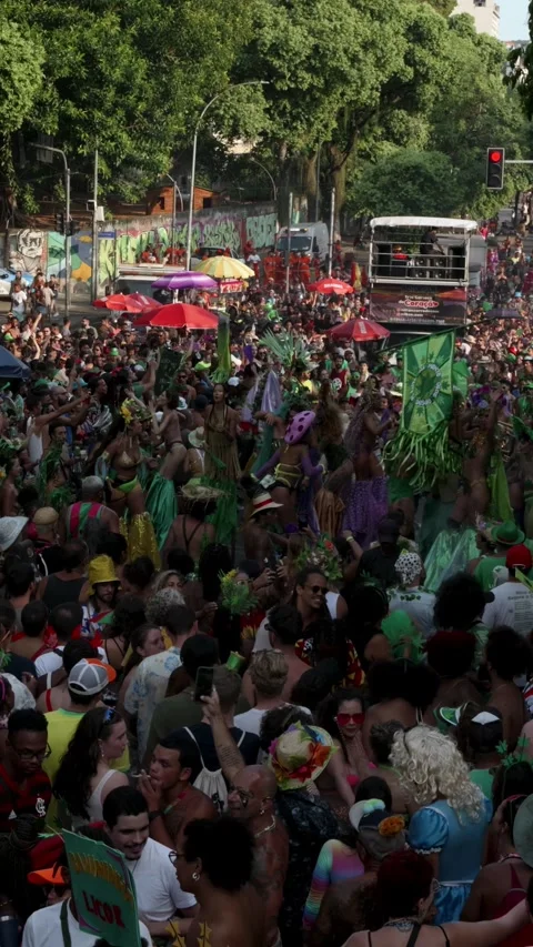 Vertical shot of a crowded Rio Carnaval bloco with people dancing near Arcos da Stock Footage 336312863