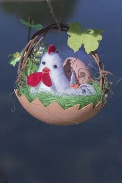 Vertical shot of a cute Easter craft hanging on a tree Foto stock
