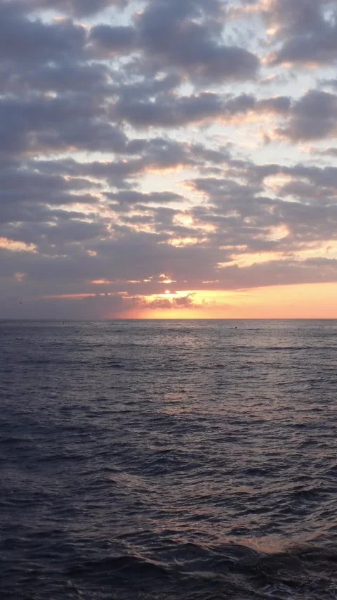 Vertical shot of dawn between clouds over the sea Stock Footage 283865998