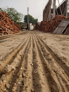 Vertical shot of a  desert soil on a construction site near a pile of bricks 写真素材