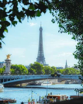 Vertical shot of an Eifel Tower and a bridge in Paris on a summer Stock Photos