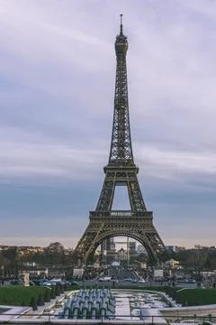 Vertical shot of the Eiffel tower on background of the scenic sunset Stock Photos