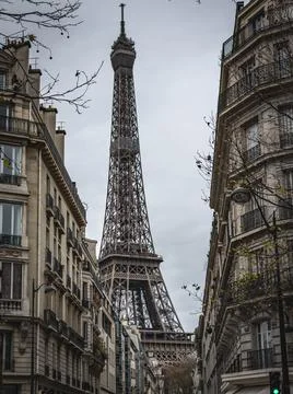 Vertical shot of Eiffel tower from a block in Paris against clear sky Stock Photos