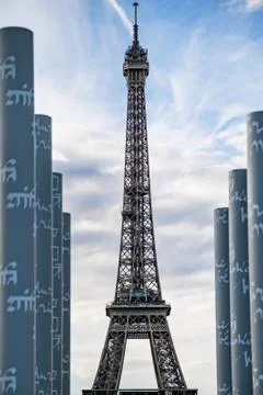 A vertical shot of an Eiffel Tower in Paris, France with a cloudy sky in the  Stock Photos