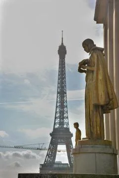 Vertical shot of the Eiffel Tower in Paris, France next to a statue Stock Photos