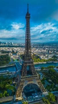 Vertical shot of Eiffel Tower under a blue sky in the evening in Paris, France Stock Photos