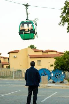 Vertical shot - Engineer looking at cable car ride during safety testing. Stock Photos