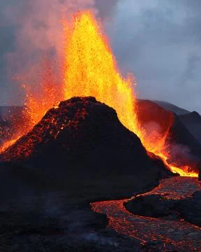 Vertical shot of exploding burning lava near a volcano Stock Photos