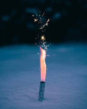 Vertical shot of an exploding firework on a floor Foto stock
