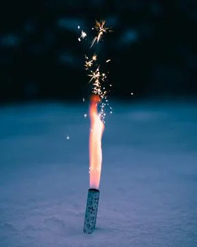 Vertical shot of an exploding firework on a floor Foto stock