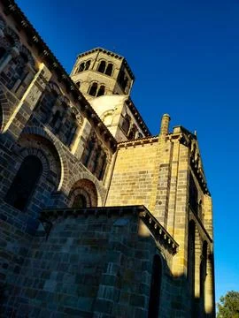 Vertical shot of the exterior of Abbatiale Saint Austremoine Romanesque church i Stock Photos
