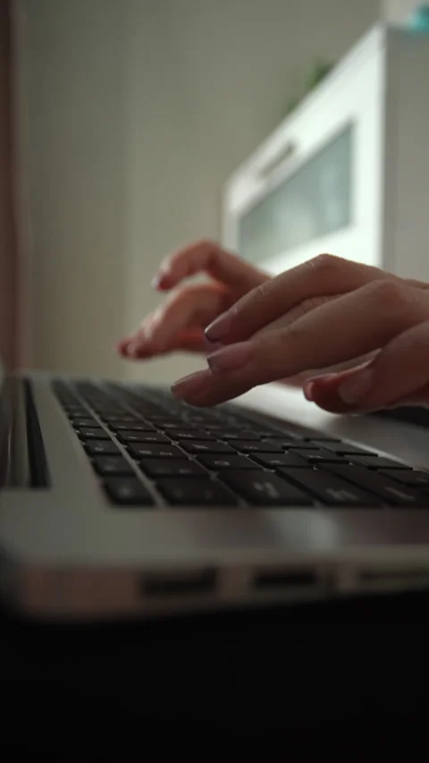 Vertical shot of female hands typing on laptop keyboard. Woman working on Vídeos de archivo 342764178