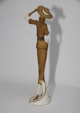 A Vertical Shot Of A Figurine In Hat Stock Photos