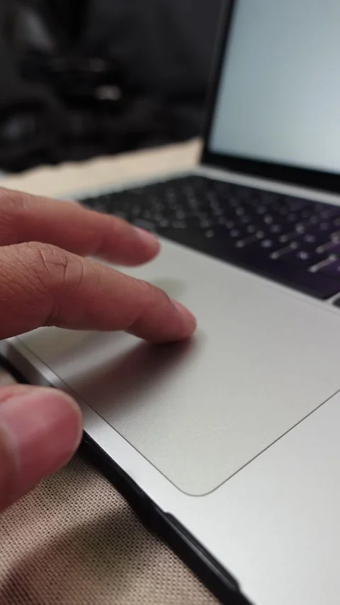 Vertical shot of  a finger navigating the cursor on a laptop touchpad Stock Footage 312413492
