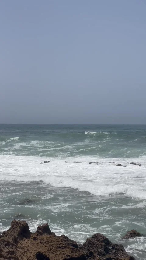 Vertical Shot of Foamy Ocean Waves Rolling to Shore Stock Footage 340775139