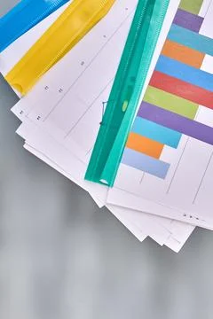 Vertical shot folders with work papers on blurred background. Stock Photos