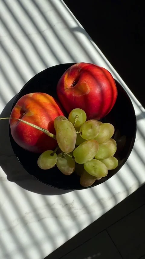 Vertical Shot of Fresh Nectarines and Green Grapes Bowl Stock-Footage 342134177