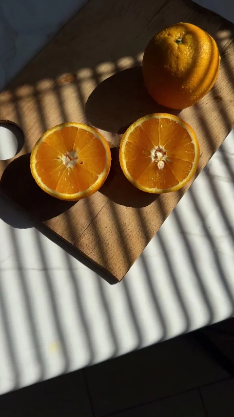 Vertical Shot of Fresh Orange Juice and Slice in Sunlight Stock-Footage 342132682