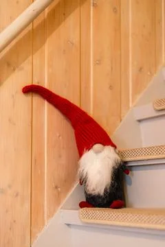 Vertical shot of a funny pixie toy on the wooden stairs Stock Photos