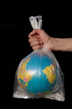 Vertical shot of Globe in a plastic bag. Save Earth Concept. Foto stock