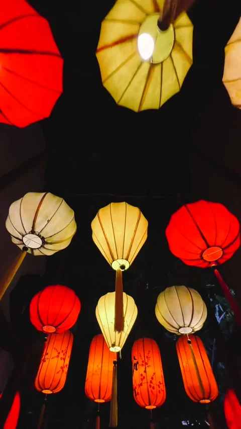 Vertical shot of Glowing Vietnamese lanterns above decorated street at night. Stock-Footage 339267654