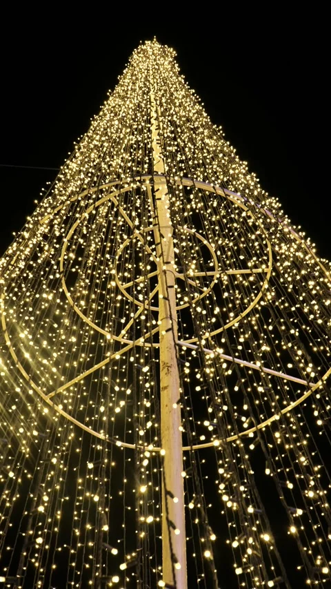 Vertical shot of golden light strings forming christmas tree 動画素材 222066502