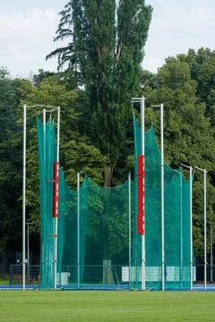 Vertical shot of a green discus throwing cage with protective safety net at.. Stock Photos