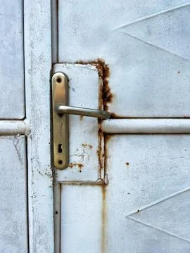 Vertical shot of a handle lock of an old metal rusty door Photos