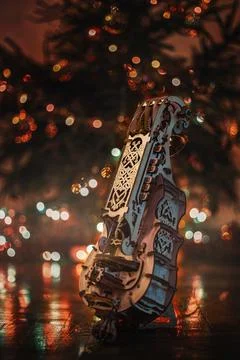 Vertical shot of a handmade string instrument in a Christmas park at night Stock Photos